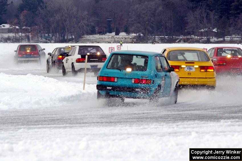 Tony Burhans / Dan Burhans II SAAB 9-3 and Brad Johnson / Morgan Johnson VW Rabbit follow the rest of the field