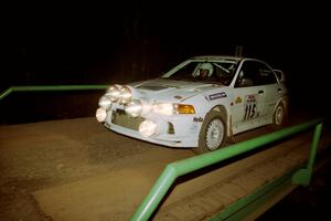 Seamus Burke / Frank Cunningham Mitsubishi Lancer Evo IV at speed across the final bridge on SS10, Menge Creek.