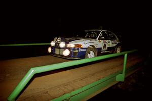 Karl Scheible / Russ Hughes Mitsubishi Lancer Evo V at speed across the final bridge on SS10, Menge Creek.