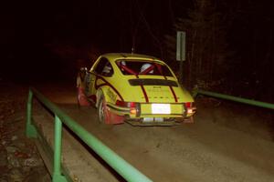 Dennis Chizma / Claire Chizma Porsche 911 at speed across the final bridge on SS10, Menge Creek.