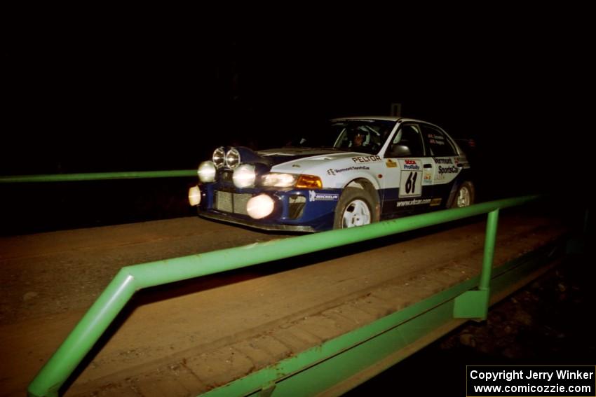 Karl Scheible / Russ Hughes Mitsubishi Lancer Evo V at speed across the final bridge on SS10, Menge Creek.