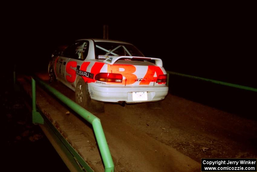 Henry Krolikowski / Cindy Krolikowski Subaru WRX STi at speed across the final bridge on SS10, Menge Creek.