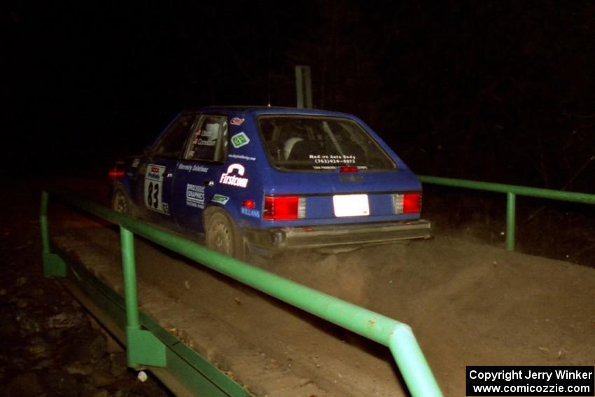 Mark Utecht / Brenda Corneliusen Dodge Omni GLH Turbo at speed across the final bridge on SS10, Menge Creek.