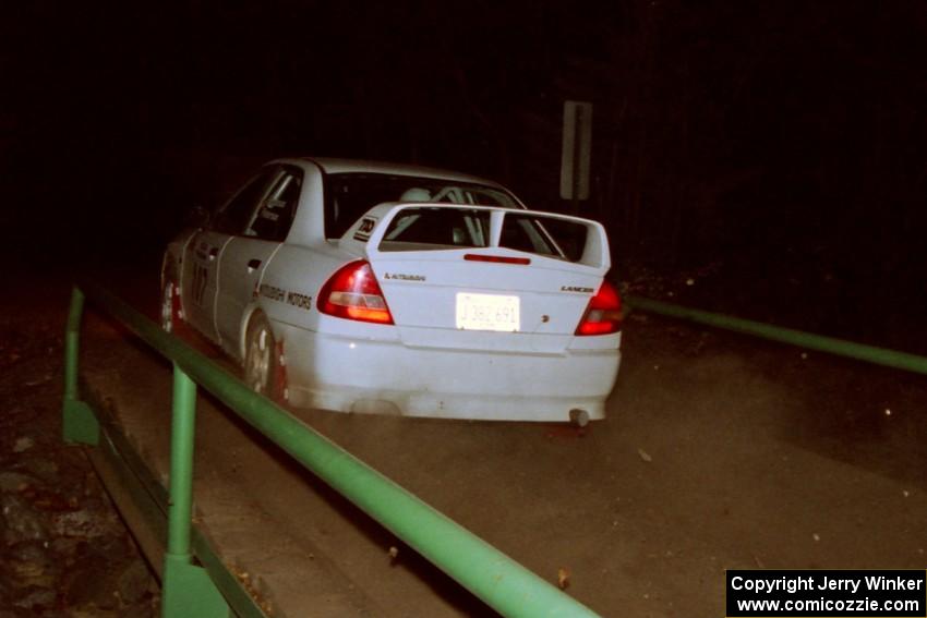 Tim Paterson / Scott Ferguson Mitsubishi Lancer Evo IV at speed across the final bridge on SS10, Menge Creek.