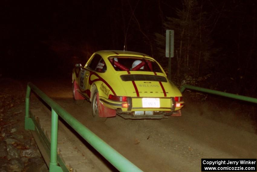 Dennis Chizma / Claire Chizma Porsche 911 at speed across the final bridge on SS10, Menge Creek.