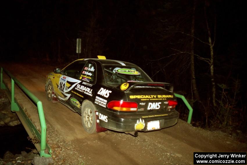 Pat Richard / Ben Bradley Subaru Impreza 2.5RS at speed across the final bridge on SS10, Menge Creek.