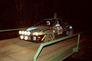 Jonathan Ryther / Janice Damitio Subaru Impreza 2.5RS at speed across the final bridge on SS10, Menge Creek.