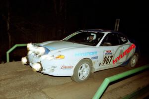 Perry King / Mark Williams Hyundai Tiburon at speed across the final bridge on SS10, Menge Creek.