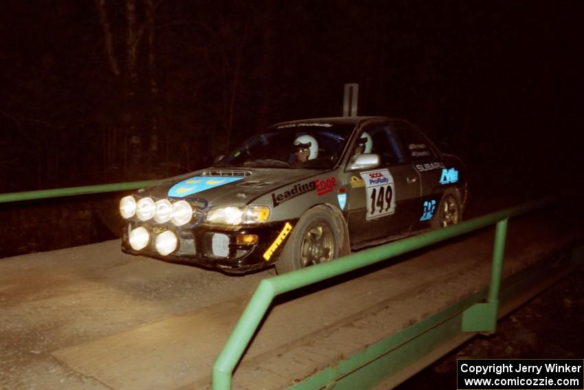 Jonathan Ryther / Janice Damitio Subaru Impreza 2.5RS at speed across the final bridge on SS10, Menge Creek.