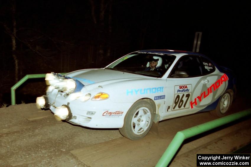 Perry King / Mark Williams Hyundai Tiburon at speed across the final bridge on SS10, Menge Creek.