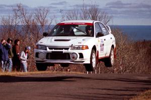 Tim Paterson / Scott Ferguson Mitsubishi Lancer Evo IV catches decent air at the final yump on SS13, Brockway Mountain.