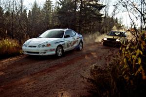 Art Burmeister / Bob Martin VW GTI passes the Perry King / Mark Williams Hyundai Tiburon near the end of SS17, Gratiot Lake II.