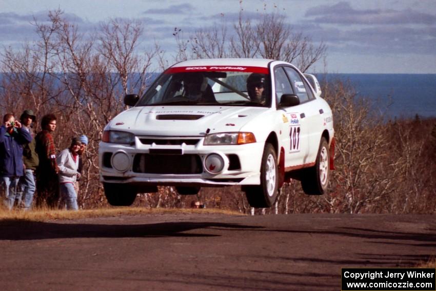 Tim Paterson / Scott Ferguson Mitsubishi Lancer Evo IV catches decent air at the final yump on SS13, Brockway Mountain.