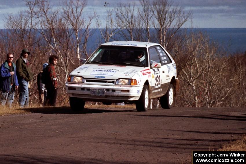 Mark Tabor / Kevin Poirier Mazda 323GTX at the final yump on SS13, Brockway Mountain.