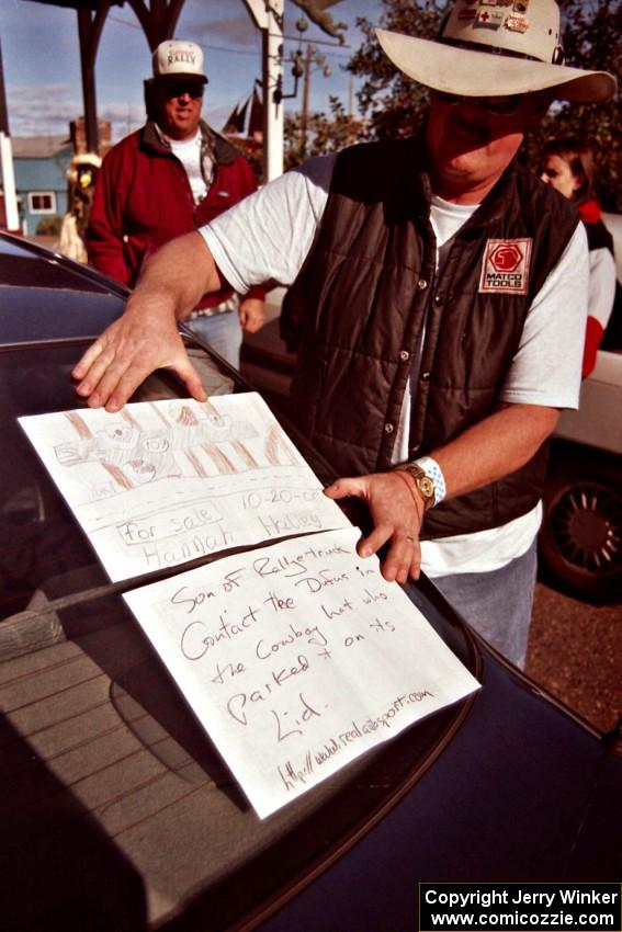 Mike Halley holds up a drawing that his daughter made of the Mitsubishi Mighty Max he and navigator Emily Burton-Weinman rolled.