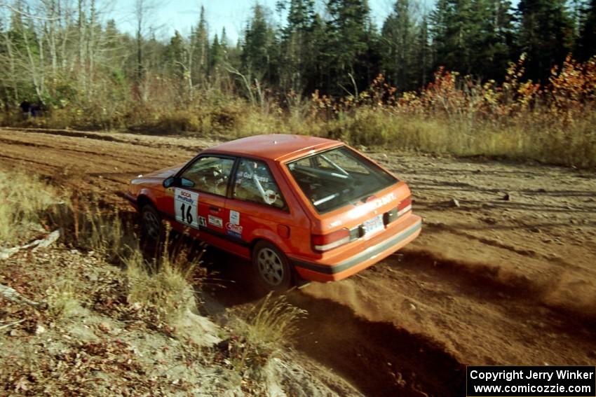 Gail Truess / Pattie Hughes Mazda 323GTX at speed near the end of SS17, Gratiot Lake II.