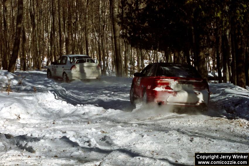 Shane Mitchell / Paul Donnelly Eagle Talon about to pass the Tim Paterson / Scott Ferguson Mitsubishi Lancer Evo IV on SS5.