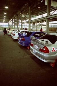 A fleet of six TAD Racing Mitsubishi Lancer Evos at parc expose.