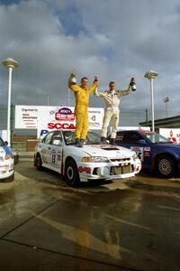 Richard Tuthill / John Bennie pose on top of their winning Mitsubishi Lancer Evo IV.