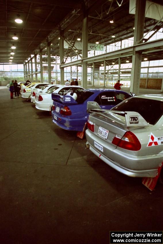 A fleet of six TAD Racing Mitsubishi Lancer Evos at parc expose.