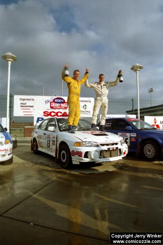 Richard Tuthill / John Bennie pose on top of their winning Mitsubishi Lancer Evo IV.