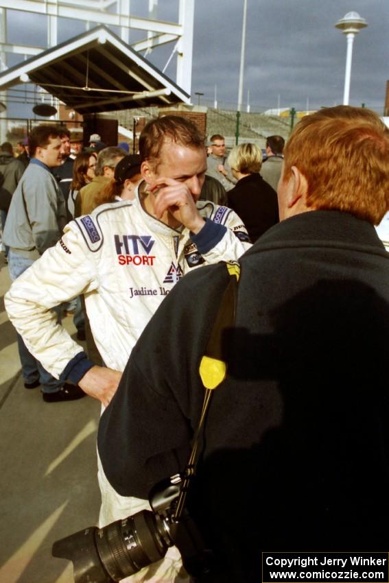 Winner Richard Tuthill is interviewed after the champagne spray.