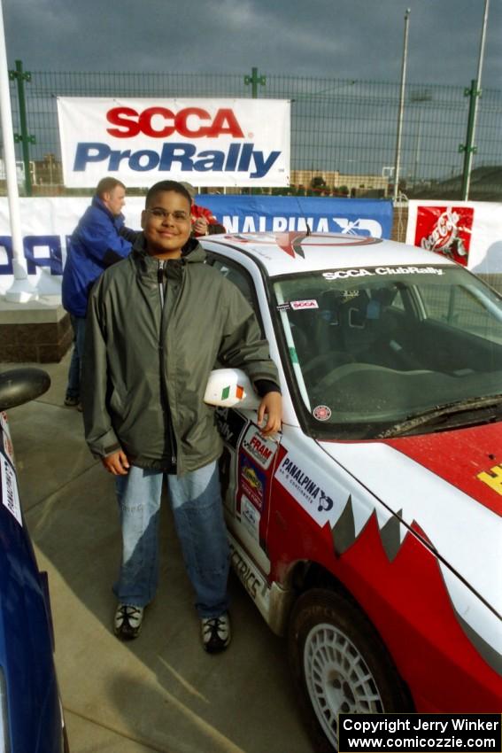 A 14-year old Alex Kihurani stands next to the Noel Nash / Patrick McGrath Mitsubishi Lancer Evo IV.