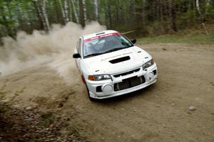 Paul Dunn / Rebecca Dunn drift through a 90-right on SS1, Indian Creek Rd., in their Mitsubishi Lancer Evo IV.