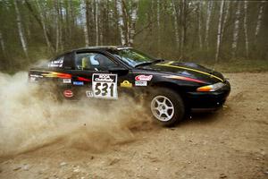 Steve Nielsen / Garrett Sturzl drift their Plymoth Laser through a 90-right on Indian Creek Rd., SS1.