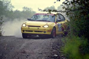 Dave Johnson / Shannon Johnson drift their Dodge Neon ACR over a blind crest in the Two Inlets State Forest.