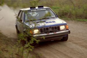 The Mary Utecht / Heidi Meyers Dodge Omni GLH Turbo at speed in the Two Inlets State Forest.