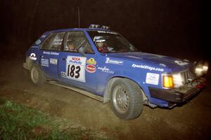 Mary Utecht / Heidi Meyers drift their Dodge Omni GLH Turbo through the crossroads on the final stage of the night.