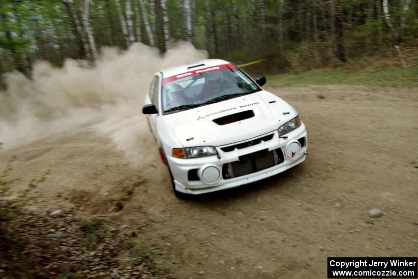 Paul Dunn / Rebecca Dunn drift through a 90-right on SS1, Indian Creek Rd., in their Mitsubishi Lancer Evo IV.