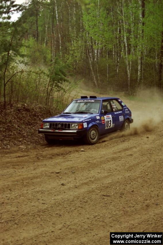 Mary Utecht / Heidi Meyers drift their Dodge Omni GLH Turbo through a 90-right on Indian Creek Rd., SS1.