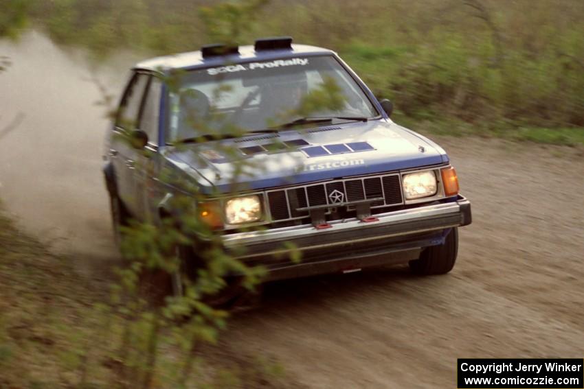 The Mary Utecht / Heidi Meyers Dodge Omni GLH Turbo at speed in the Two Inlets State Forest.