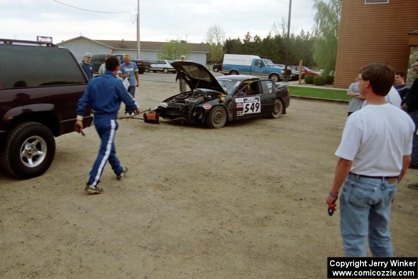 Thanasi Samaras / Constantine Koutras try to tow their Eagle Talon through service, but pull too hard and lose the bumper.