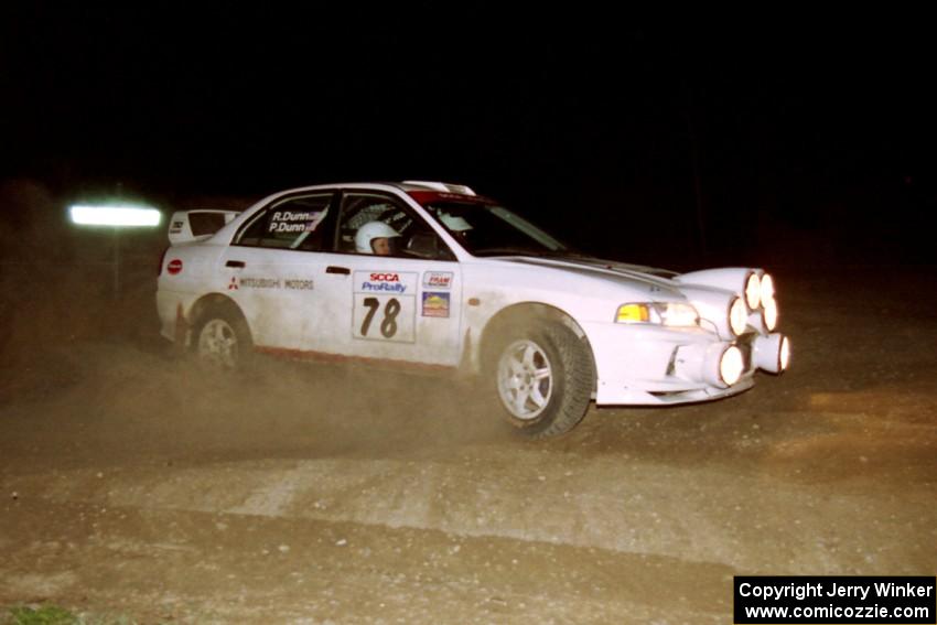Paul Dunn / Rebecca Dunn drift their Mitsubishi Lancer Evo IV through the crossroads on the final stage of the rally.