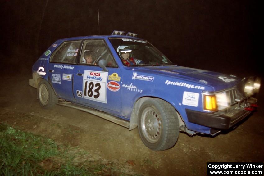 Mary Utecht / Heidi Meyers drift their Dodge Omni GLH Turbo through the crossroads on the final stage of the night.
