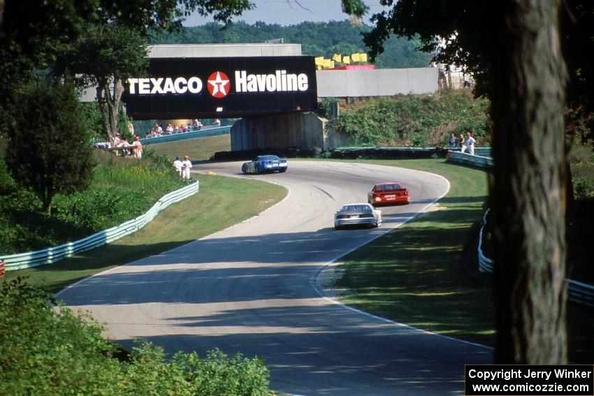 Jerry Simmons' Chevy Corvette ahead of Tommy Archer's Dodge Daytona and Jim Derhaag's Chevy Corvette