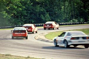 The  Eagle Talon ESs of Neil Hanneman, Bill Saunders and Oscar Peralta, followed by Joe Danaher's Chevy Camaro