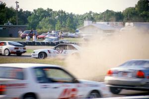 Terry Borcheller's Ford Saleen Mustang makes a bonzai move at turn 5 and starts a big collision.