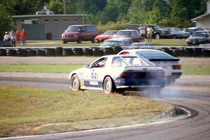 Makoto Yamamura's Mazda RX-7 loses its engine on lap two as Greg Theiss' Porsche 944 S2 passes