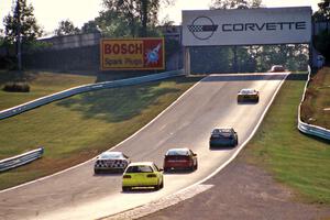 The leaders pass backmarkers on their way uphill to turn 6.