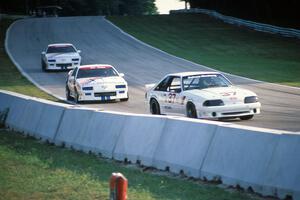 Terry Borcheller's Ford Saleen Mustang followed by the Chevy Camaros of Joe Danaher and Duke McLaughlin