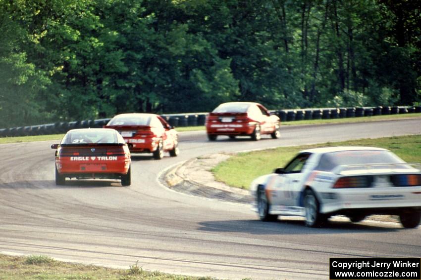 The  Eagle Talon ESs of Neil Hanneman, Bill Saunders and Oscar Peralta, followed by Joe Danaher's Chevy Camaro