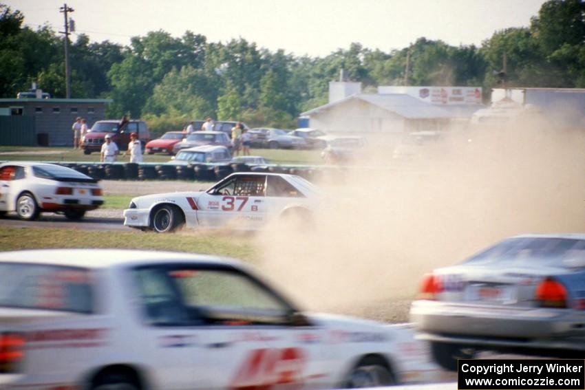 Terry Borcheller's Ford Saleen Mustang makes a bonzai move at turn 5 and starts a big collision.