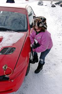 Ellie Carlson tightens lugs on the Rich Westgard / Brent Carlson Subaru Impreza