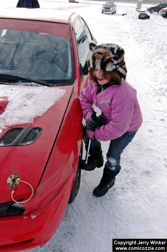 Ellie Carlson tightens lugs on the Rich Westgard / Brent Carlson Subaru Impreza