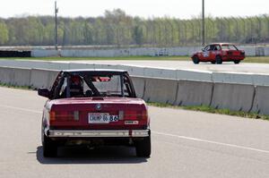 Missing Link Motorsports BMW 325i leaves the pits after a driver's change.