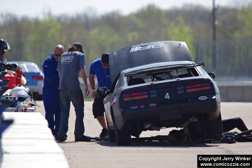 Generations Nissan 300ZX in the pits early on.